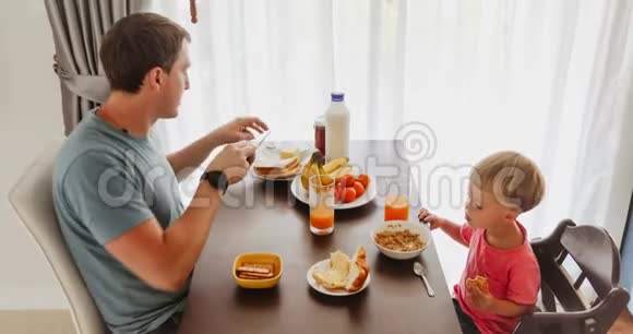 父亲和孩子享受早餐视频的预览图