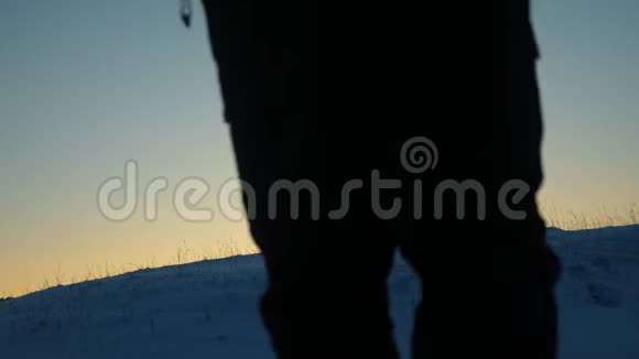 带背包的男性游客在美丽的天空和阳光的背景下爬到山顶带背包的旅行者会下雪视频的预览图