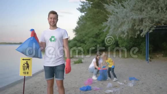 关爱自然生态戴着橡胶手套带垃圾袋的微笑志愿者画像背景上的指针标志视频的预览图