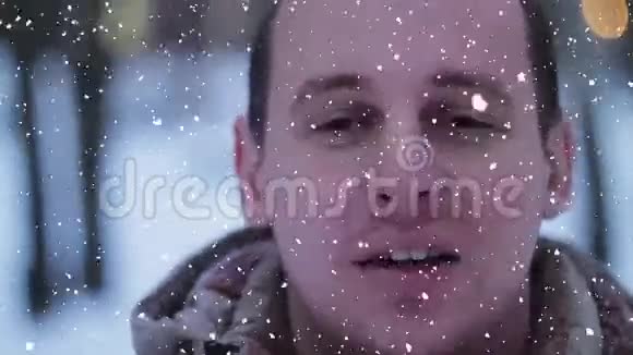 快乐的微笑男人放松快乐的男人微笑着看镜头雪效果的肖像视频的预览图