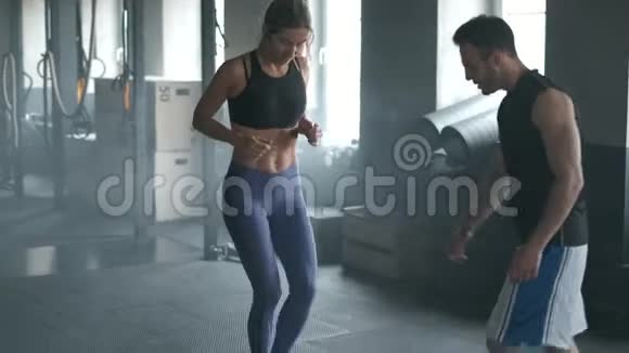 一位运动美丽运动的金发年轻女子的全身长度是一个有氧运动训练器上面系着速度带视频的预览图