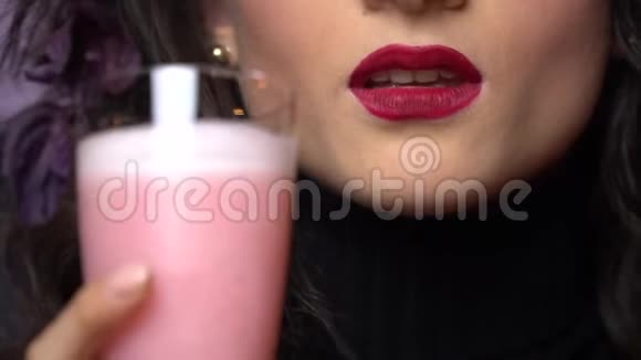 涂红唇膏的女人喝鸡尾酒舔嘴唇视频的预览图
