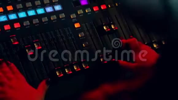 女性手在混合控制台后混合轨道为迪斯科在彩色照明视频的预览图
