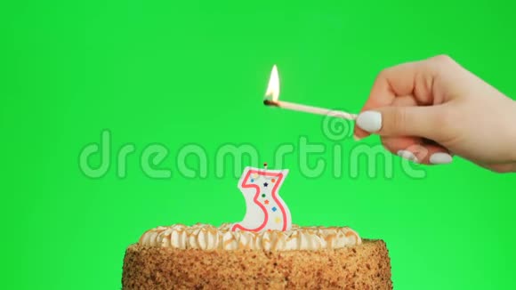 在美味的蛋糕上点燃三号生日蜡烛绿色的屏幕视频的预览图
