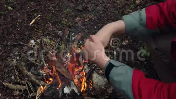 人在篝火旁暖手视频的预览图
