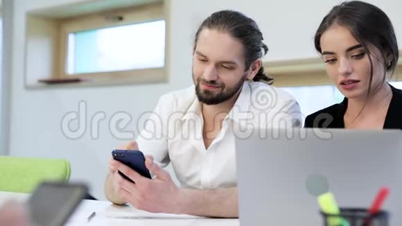 办公室男人用电话女人在工作场所用电脑视频的预览图