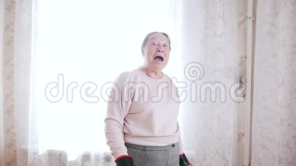 老年妇女拳击时开心微笑的肖像视频的预览图