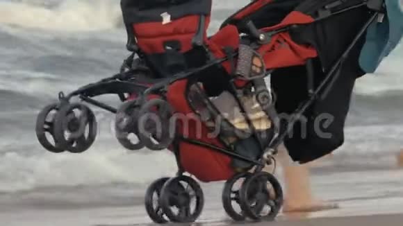 一辆红色婴儿车正沿着海滩行驶视频的预览图