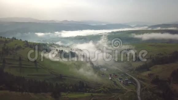 雾蒙蒙的夏日日出在山上春雾笼罩村庄视频的预览图