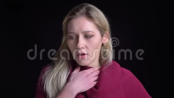 在镜头前年轻漂亮的白种人女性咽喉不适的特写镜头视频的预览图
