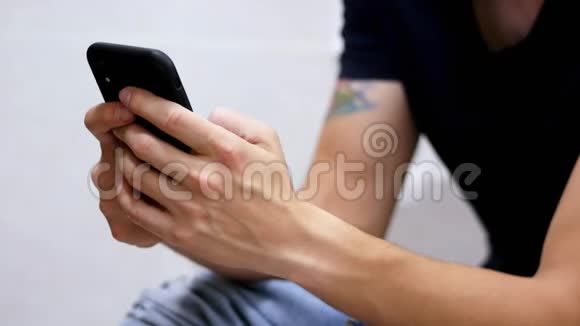 男人在厕所里用智能手机上网男性手持电话特写视频的预览图