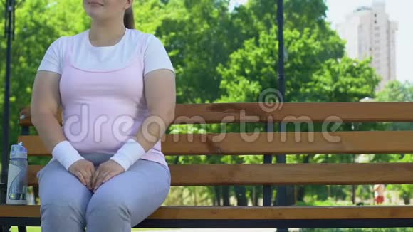 勇敢的肥胖男人坐在公园里胖乎乎的女孩旁边试图结识她视频的预览图