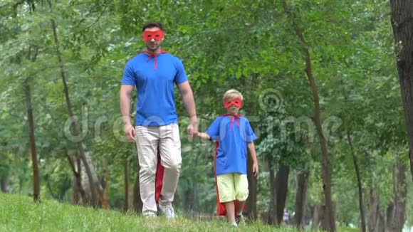父子牵手穿着超级英雄服装支持父母视频的预览图
