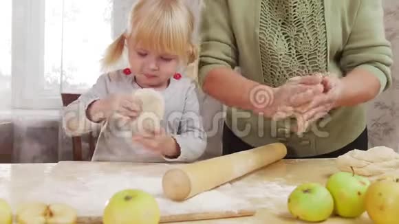 一家人做小馅饼一个小女孩咬了一口生面团把面团卷出来视频的预览图