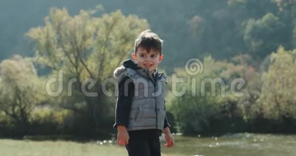 树龄男孩在大自然中和他的小哈士奇狗玩耍4k视频的预览图
