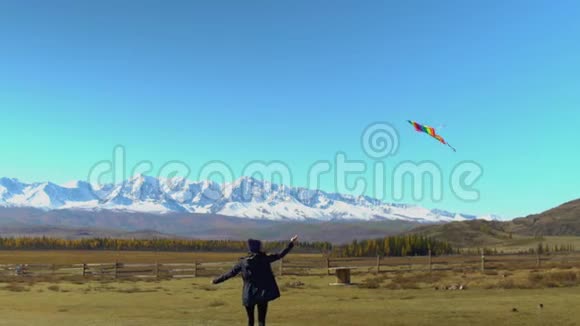 女孩带着风筝在山上到处跑自由概念视频的预览图