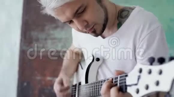 金发男用吉他工作视频的预览图