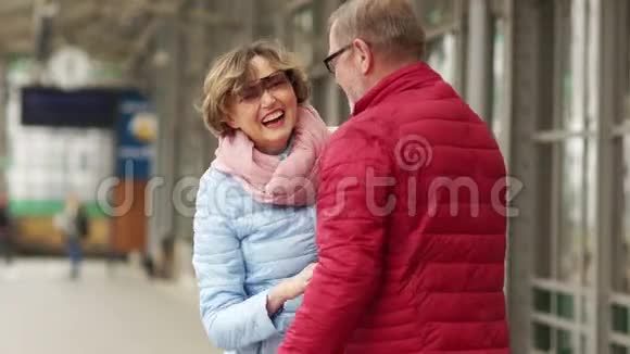 相爱的老夫妇在车站相遇一男一女拥抱欢笑情人节视频的预览图