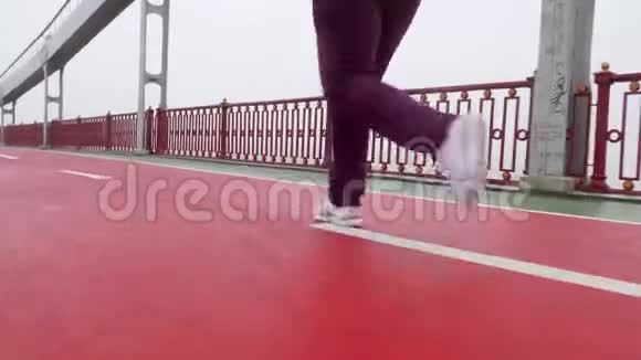 近距离拍摄一个穿着白色鞋子从摄像机里跑出来的女孩视频的预览图