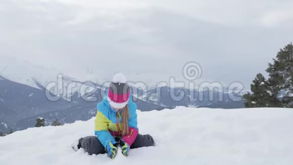 儿童坐在山顶欣赏山景视频的预览图