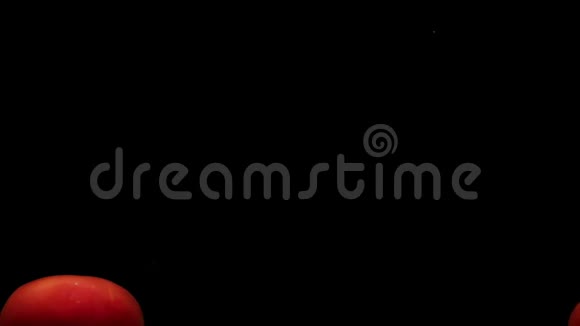 两个红色的假名躺在透明的水里黑色的背景视频的预览图