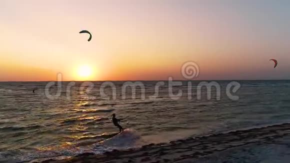 大海上美丽的日落一群人在风筝上冲浪驾驶风筝训练师视频的预览图