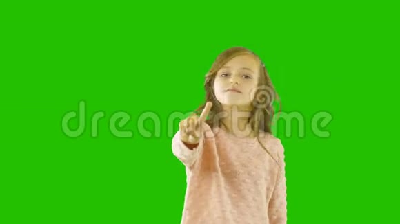一个留着卷发的小女孩看着镜头微笑着挥舞着食指和头表达着自己的情感视频的预览图
