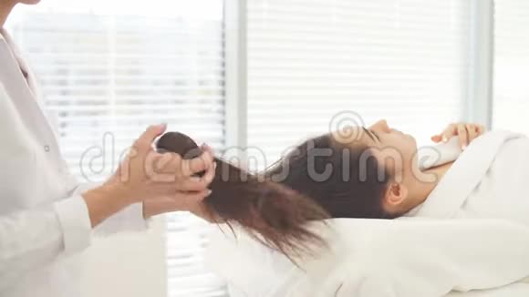 白种人黑发女人在美容院接受抗皱和皮肤恢复治疗视频的预览图