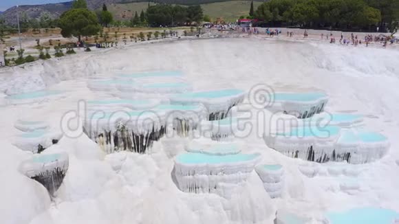 土耳其帕姆克凯尔的石灰华全景背景为游客的白色石灰岩矿层视频的预览图