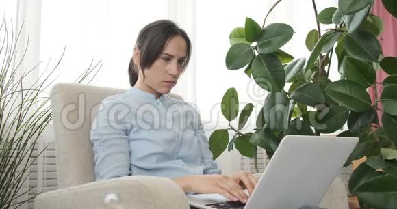 女人在笔记本电脑上收到好消息后兴奋不已视频的预览图