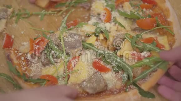 把美味可口的披萨放在木板上不同的人手拿一块披萨视频的预览图