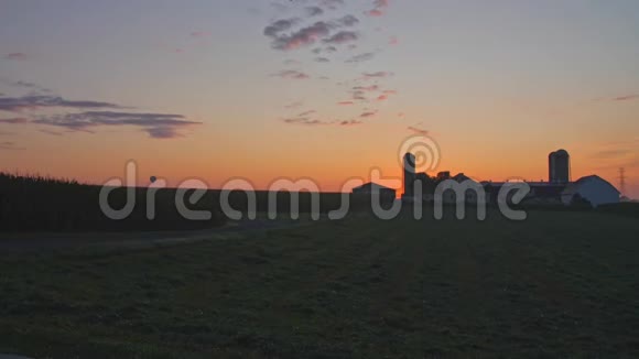 在一个多云的夏日日出时的鸟瞰农场和乡村视频的预览图