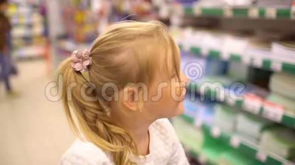 快乐的一家人在购物一家人穿过超市女孩坐在购物车里肖像视频的预览图