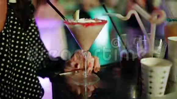 在舞会上喝鸡尾酒的女人在舞蹈俱乐部的桌子上特写鸡尾酒视频的预览图