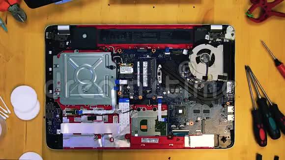 技师工程师维修笔记本电脑的俯视图拧下散热器冷却主板视频的预览图