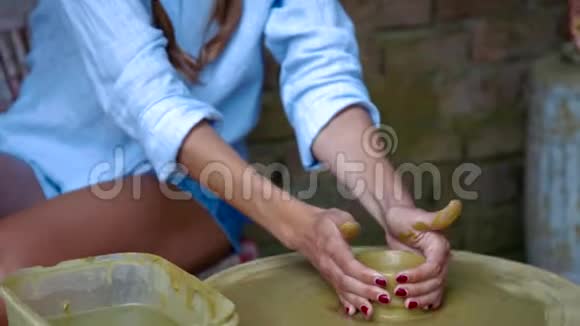 金发女孩在陶器车间里学做陶罐视频的预览图