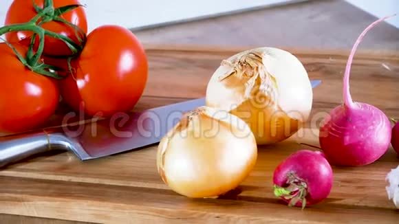 多莉菜板上的洋葱番茄刀和其他蔬菜视频的预览图