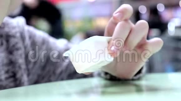 一个男孩在餐馆食品场吃快餐在一个带有酱汁的塑料一次性容器里蘸取小金块视频的预览图