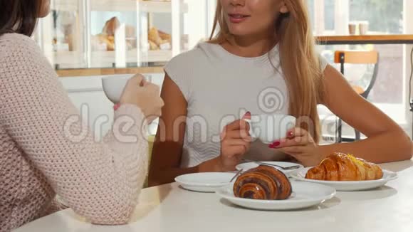 两个女人在当地的面包店喝着牛角面包视频的预览图
