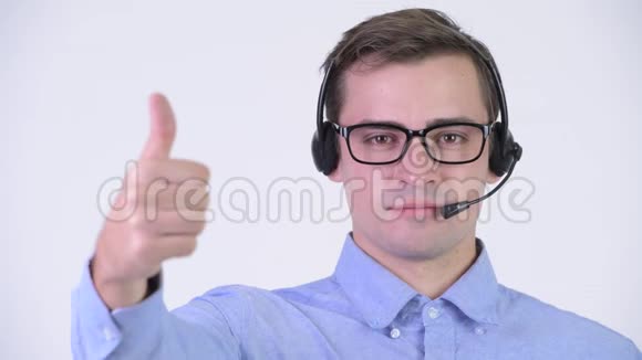 年轻快乐英俊的商人作为呼叫中心代表竖起大拇指视频的预览图