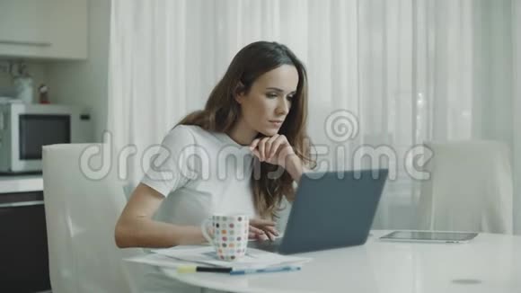 快乐的女人在家工作笔记本电脑兴奋的女人读好消息视频的预览图