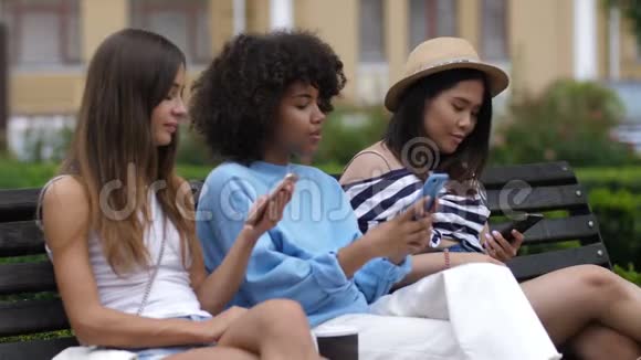 放松的多样化女孩在长凳上自拍视频的预览图