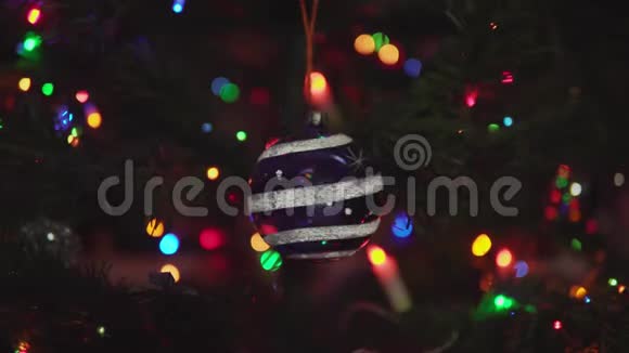 蓝色圣诞球雪花和条纹在树枝上旋转视频的预览图