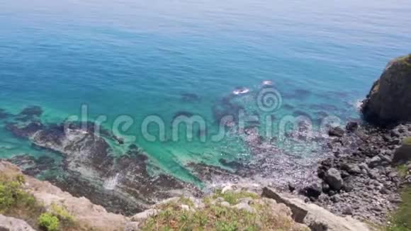 美丽的夏日海景美丽的风景岩石海岸的绿松石海和绿草视频的预览图