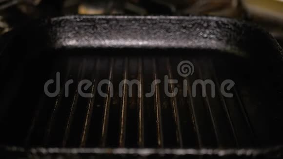 一块生肉放在热烤盘上烹饪T面牛排特写美味的脂肪垃圾食品视频的预览图