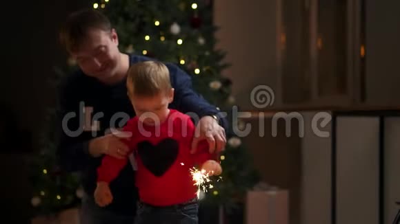 在家过圣诞节的时候带着火花的年轻家庭视频的预览图