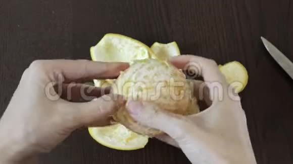 女人剥皮后她的手把橘子分成几段视频的预览图