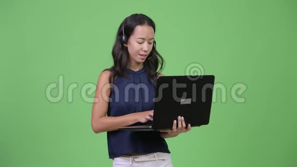 年轻漂亮的多民族女商人带着笔记本电脑担任呼叫中心代表视频的预览图
