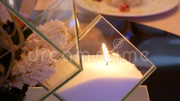 现代烛台玻璃白色蜡烛和花视频的预览图