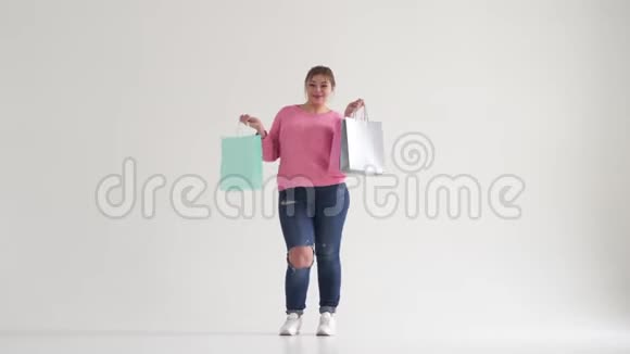 兴奋的女人拿着购物袋跳舞视频的预览图